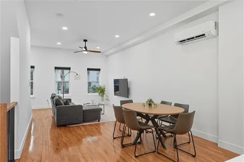 a view of a dining room with furniture and wooden floor