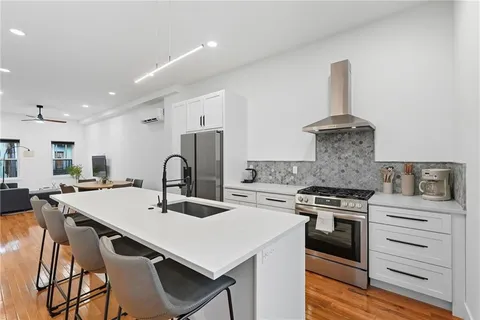 a kitchen with a stove a sink and a refrigerator