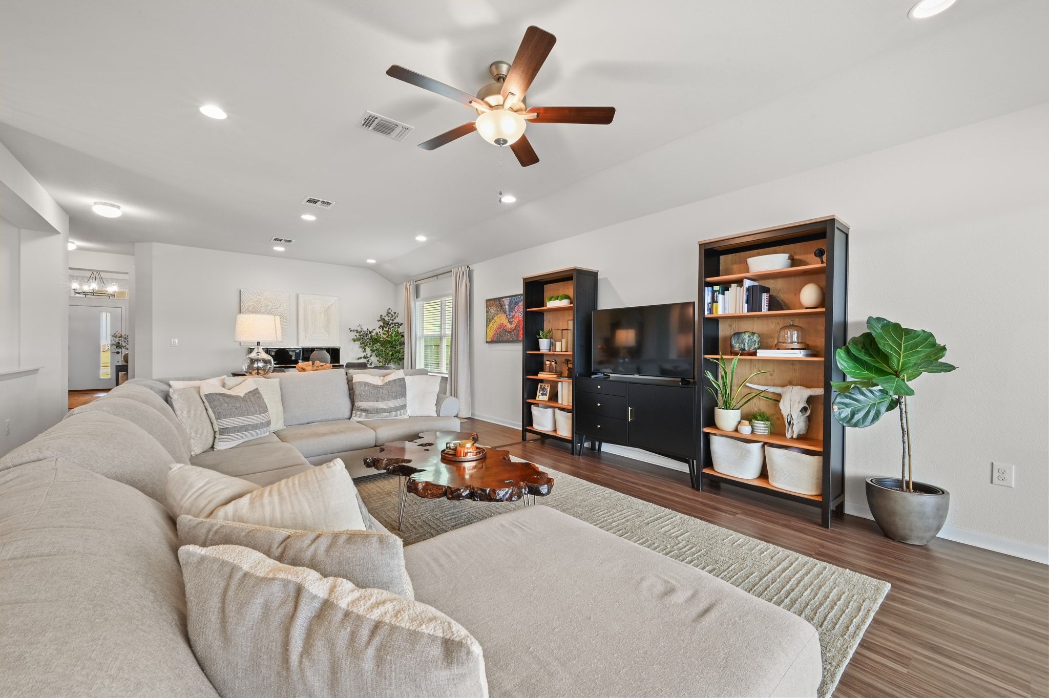 16620 Sumptuous Drive Manor, TX 78653 - Photo 12 of 40 Living area with recessed lighting, wood finished vinyl floors, and vaulted ceiling that opens to dining room, kitchen, and breakfast nook