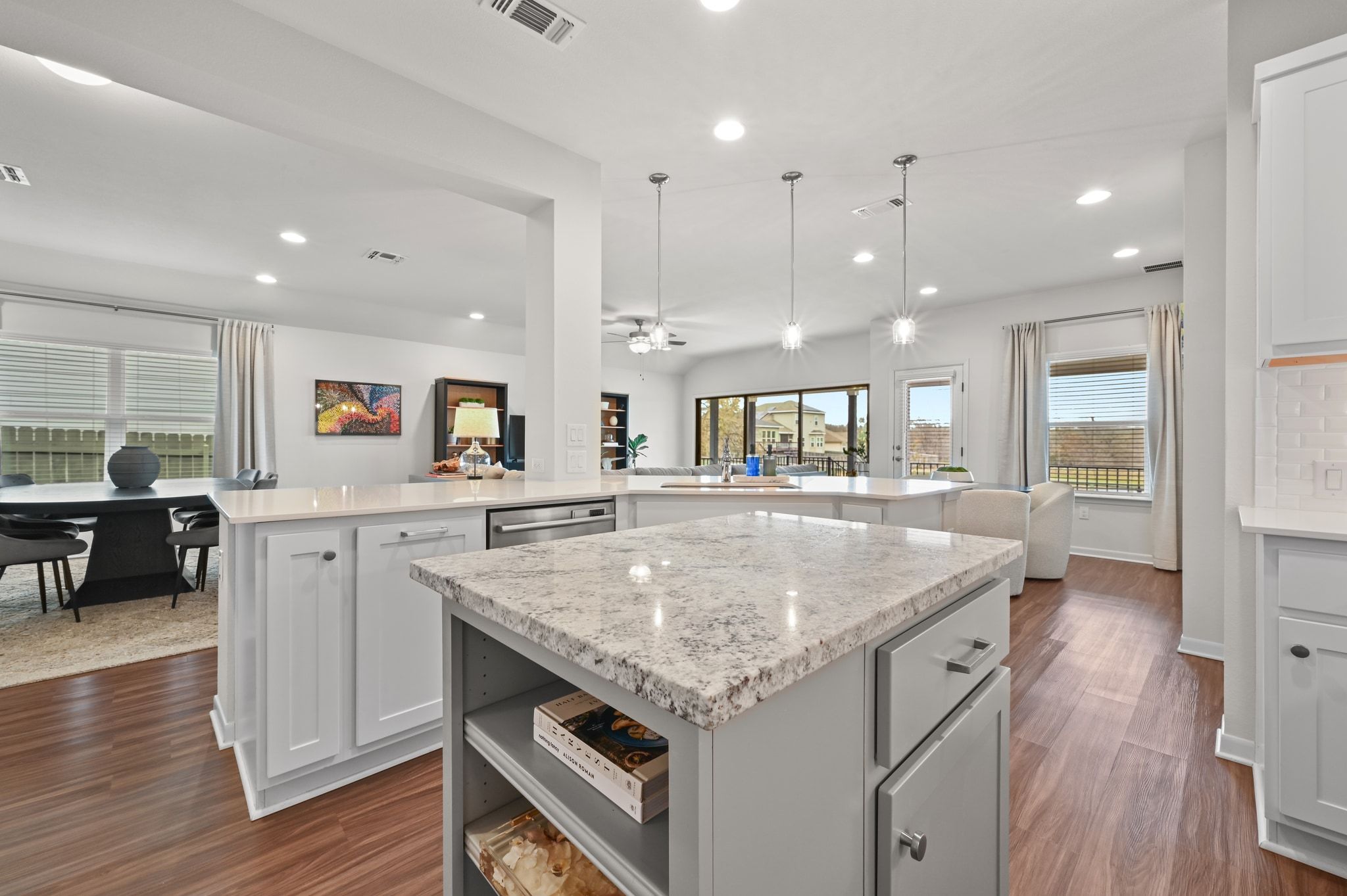 16620 Sumptuous Drive Manor, TX 78653 - Photo 15 of 40 Kitchen with white cabinetry, a center island, open shelves, and light quartz countertops