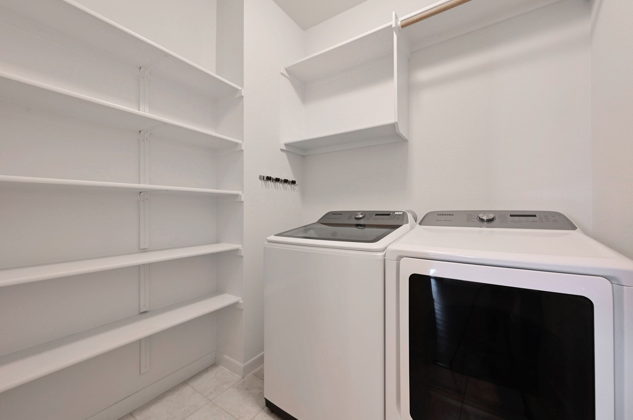 16620 Sumptuous Drive Manor, TX 78653 - Photo 23 of 40 Separate laundry room with ample storage shelves.