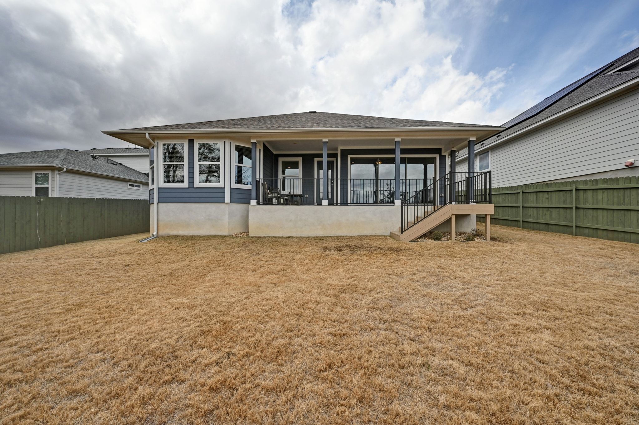 16620 Sumptuous Drive Manor, TX 78653 - Photo 30 of 40 Back of property featuring the upgraded extended pack patio and sizable yard.