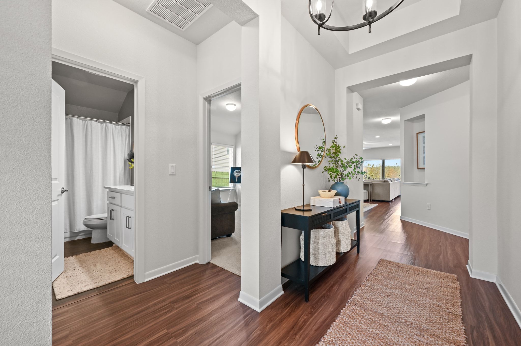 16620 Sumptuous Drive Manor, TX 78653 - Photo 5 of 40 Hallway featuring dark wood-style vinyl flooring and upgraded designer lighting