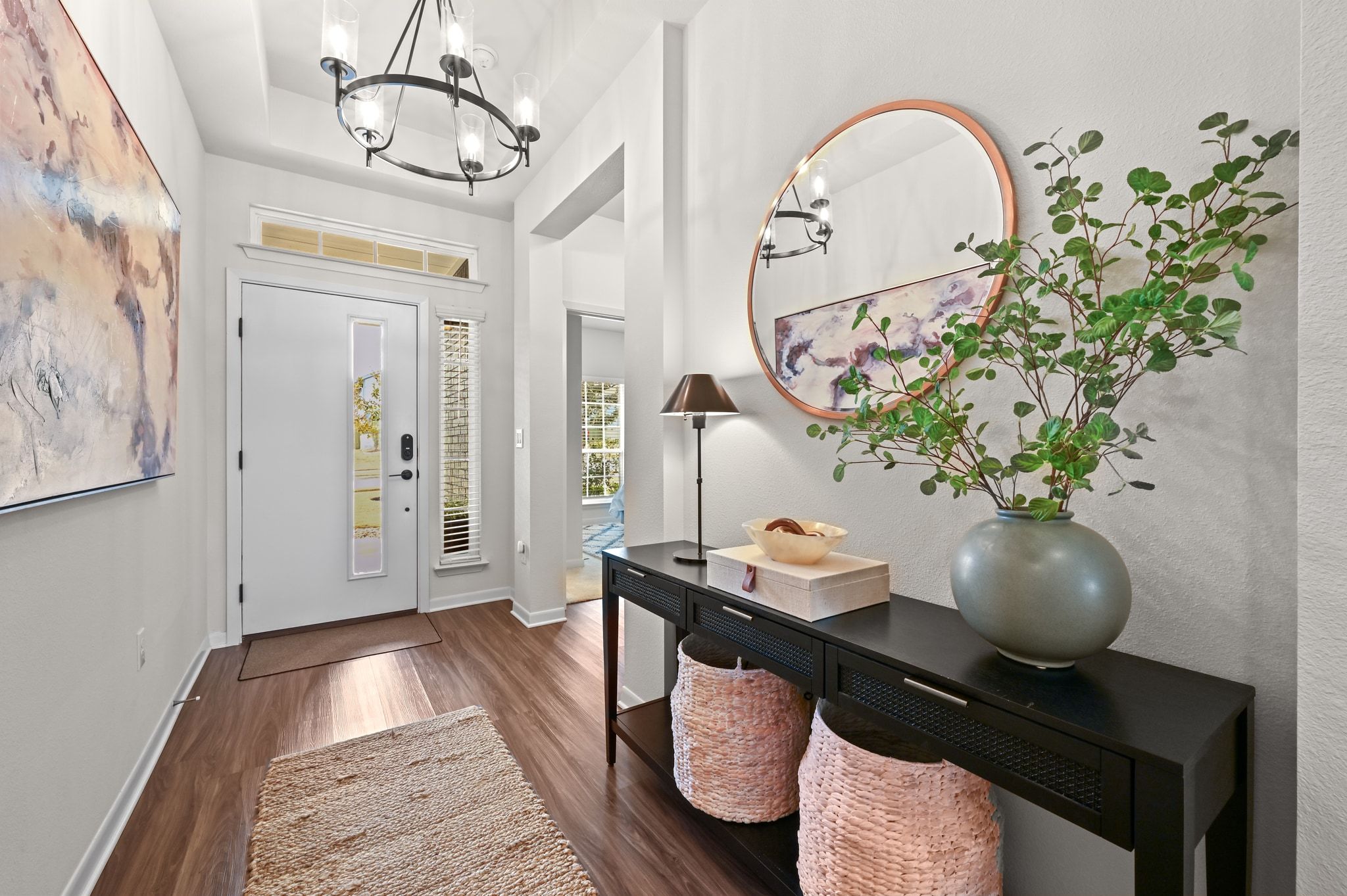 16620 Sumptuous Drive Manor, TX 78653 - Photo 6 of 40 Foyer entrance with upgraded designer lighting, dark wood-vinyl floors, and a high ceiling