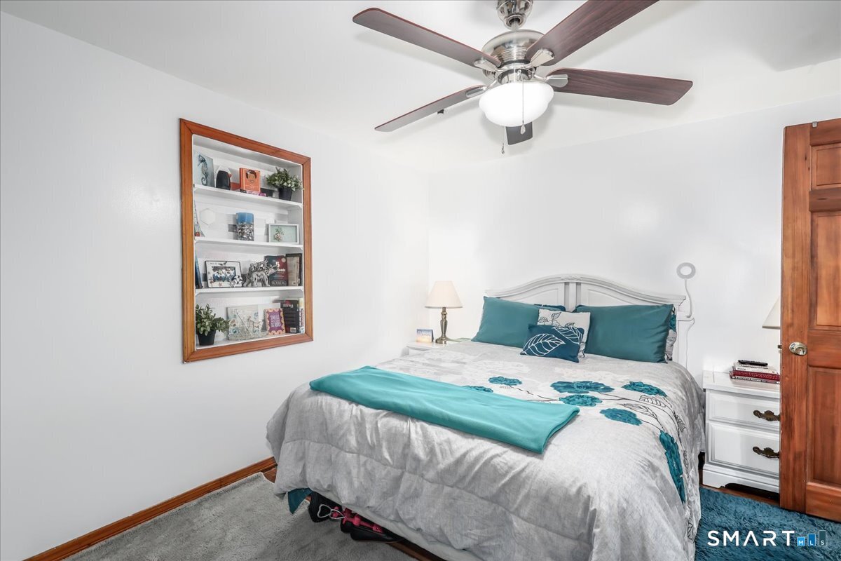 306 Welton Street Hamden, CT 06517 - Photo 16 of 38 a bedroom with a bed and a chandelier