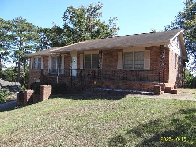 a front view of a house with a yard and a garage