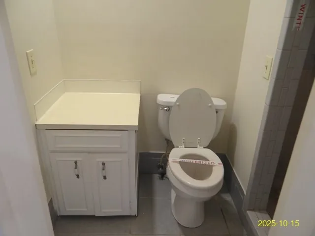a white toilet sitting next to a shower