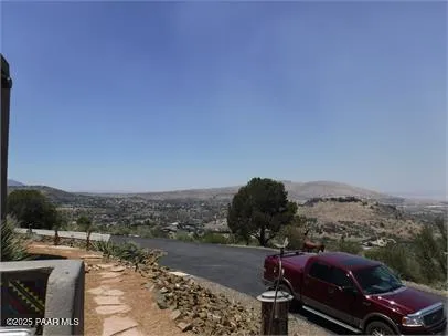 a view of roof deck with furniture and mountain view