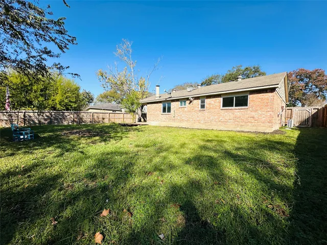 a view of a backyard with a large trees
