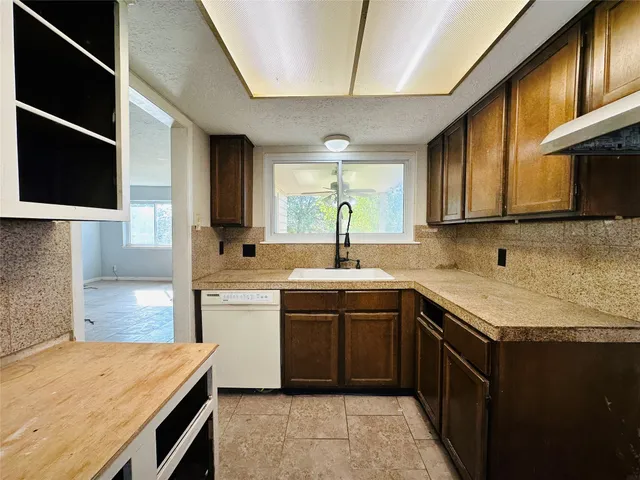 a kitchen with a sink stove and cabinets