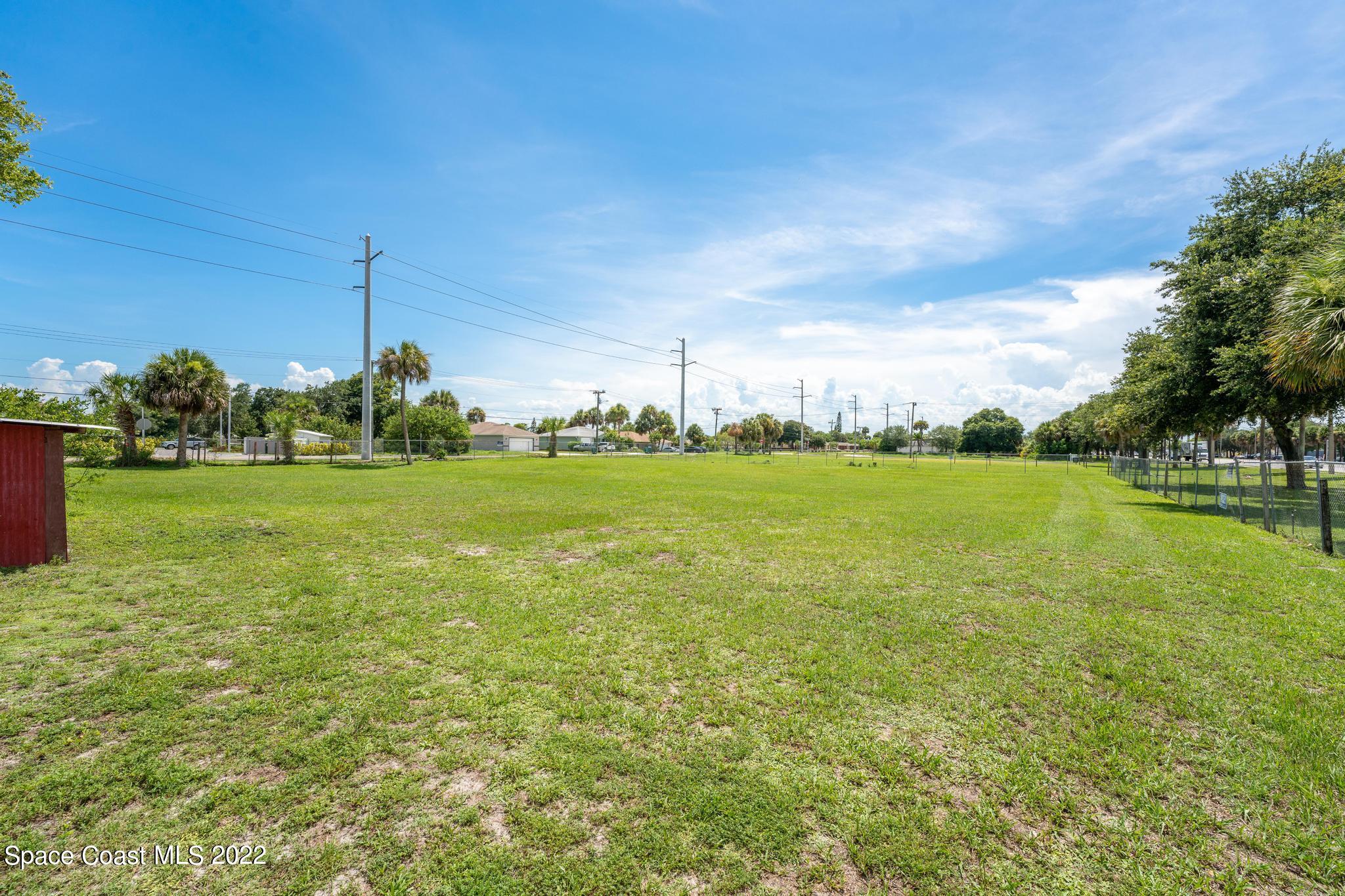 420 Stone Street Cocoa, FL 32922 - Photo 12 of 13 a view of a grassy field with an trees