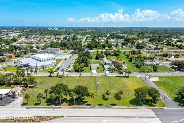 an aerial view of residential houses with outdoor space and river