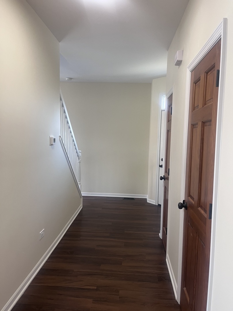 547 Goodwin Drive Bolingbrook, IL 60440 - Photo 12 of 36 a view of a hallway with wooden floor and staircase