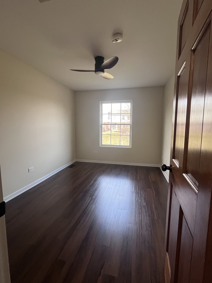 547 Goodwin Drive Bolingbrook, IL 60440 - Photo 19 of 36 wooden floor in an empty room with a window