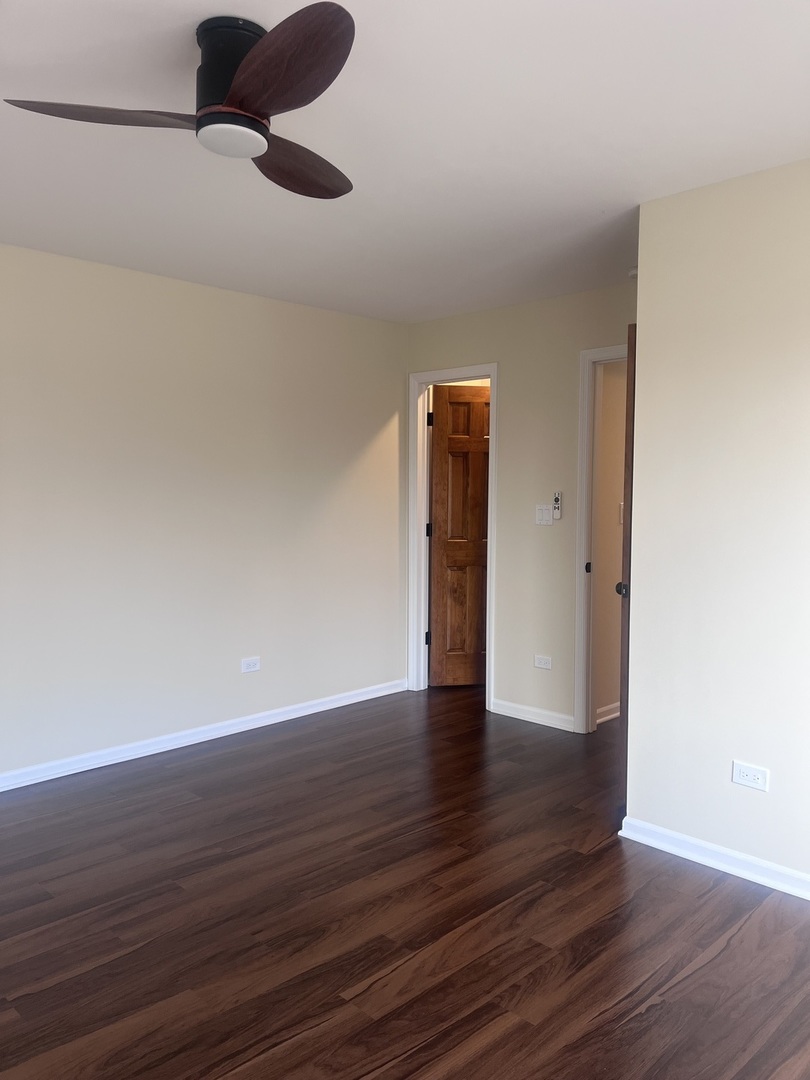 547 Goodwin Drive Bolingbrook, IL 60440 - Photo 22 of 36 a view of an empty room and wooden floor