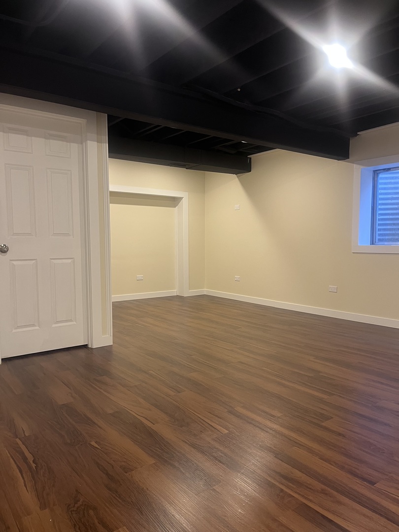 547 Goodwin Drive Bolingbrook, IL 60440 - Photo 28 of 36 a view of an empty room with wooden floor and a window
