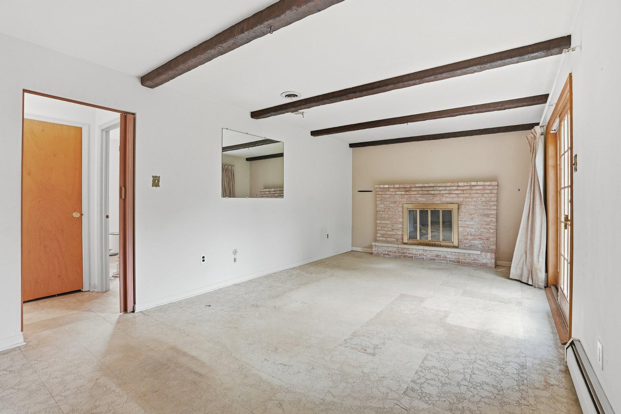 330 Wexford Road Red Hill, PA 18076 - Photo 23 of 54 an empty room with a fireplace and a window
