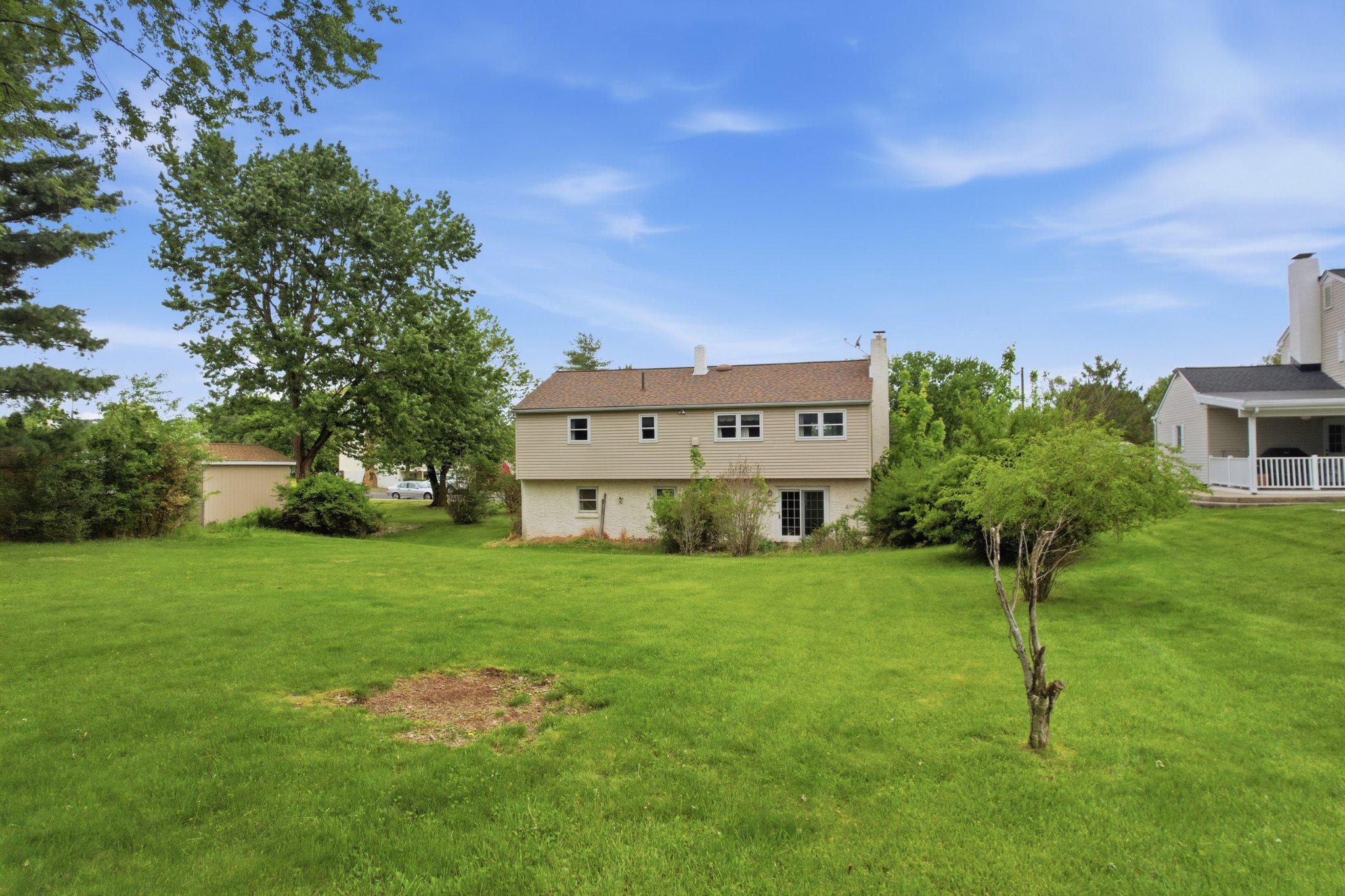 330 Wexford Road Red Hill, PA 18076 - Photo 38 of 54 a view of a house with a big yard potted plants and a large tree