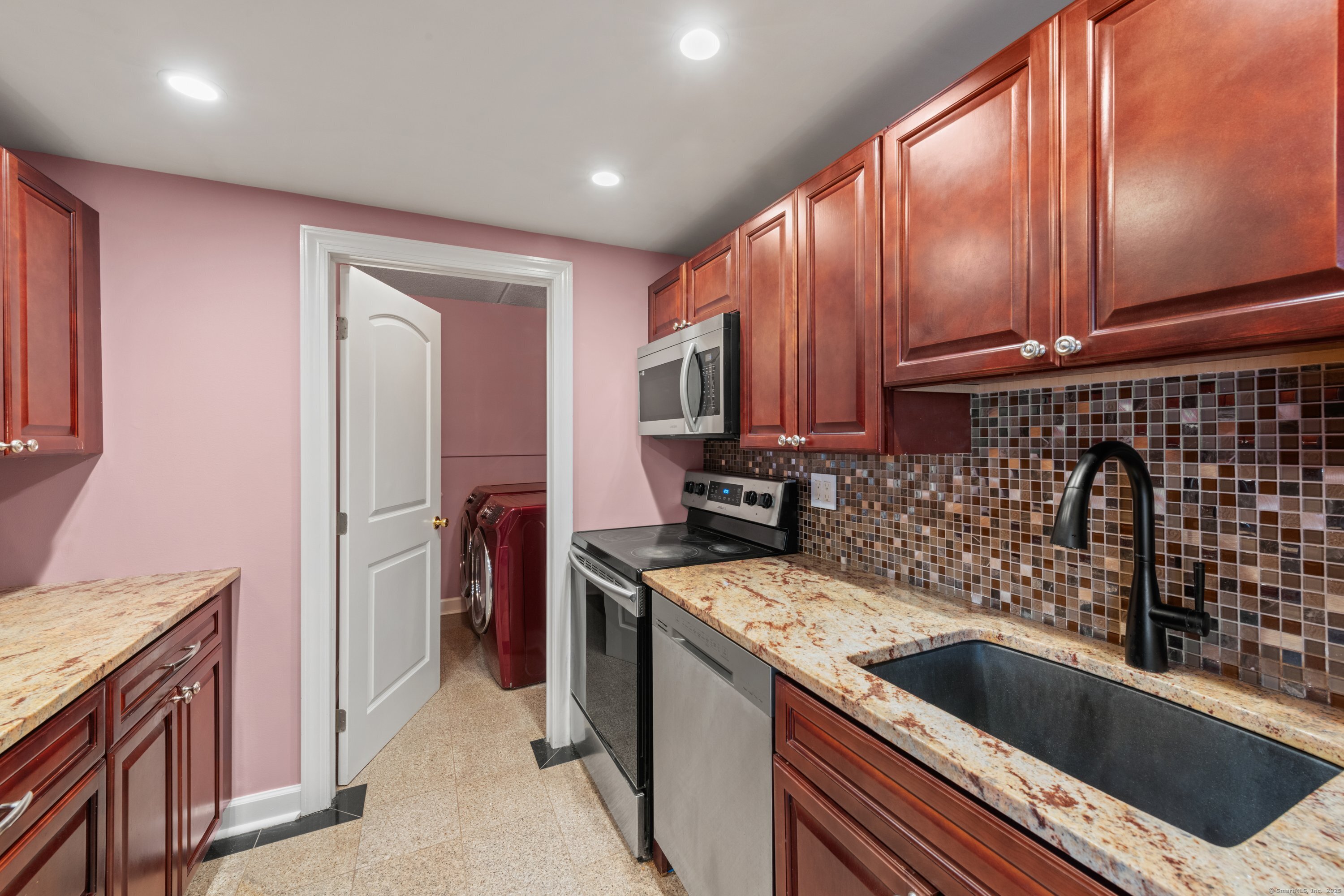 143 Hoyt Street, Unit 1A Stamford, CT 06905 - Photo 15 of 32 a kitchen with a sink cabinets and refrigerator