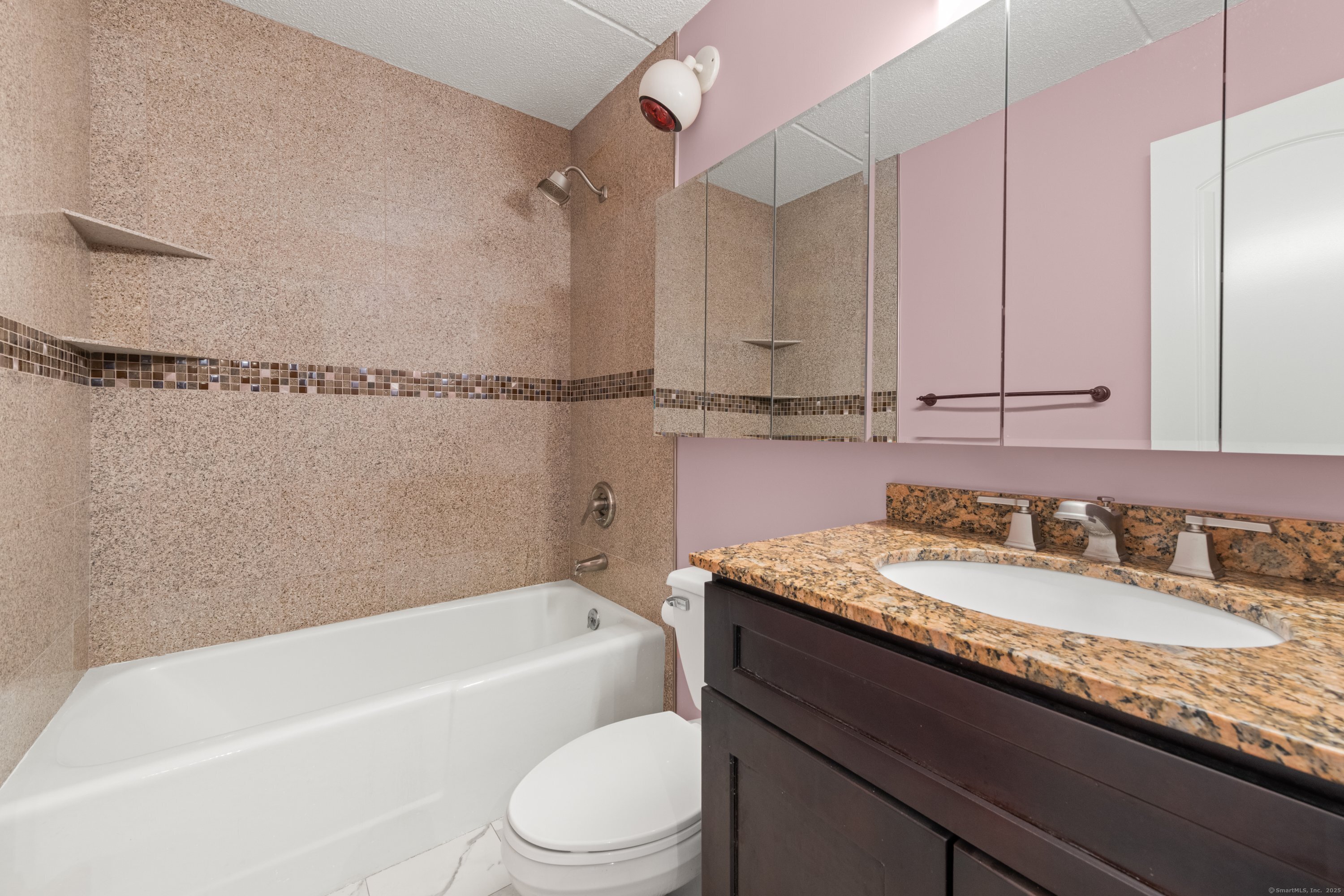 143 Hoyt Street, Unit 1A Stamford, CT 06905 - Photo 19 of 32 a bathroom with a granite countertop bathtub sink vanity mirror and toilet
