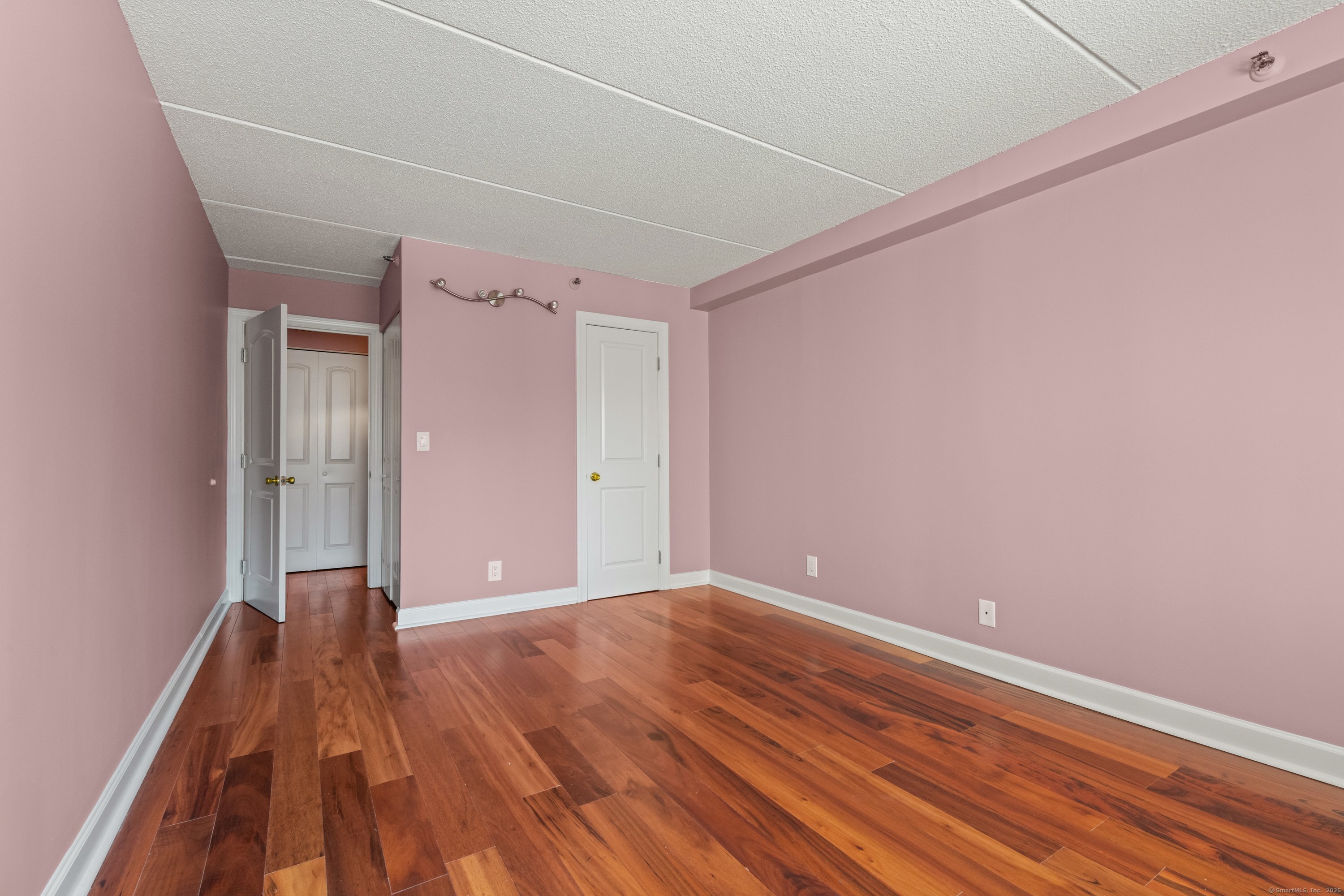 143 Hoyt Street, Unit 1A Stamford, CT 06905 - Photo 21 of 32 a view of an empty room with wooden floor