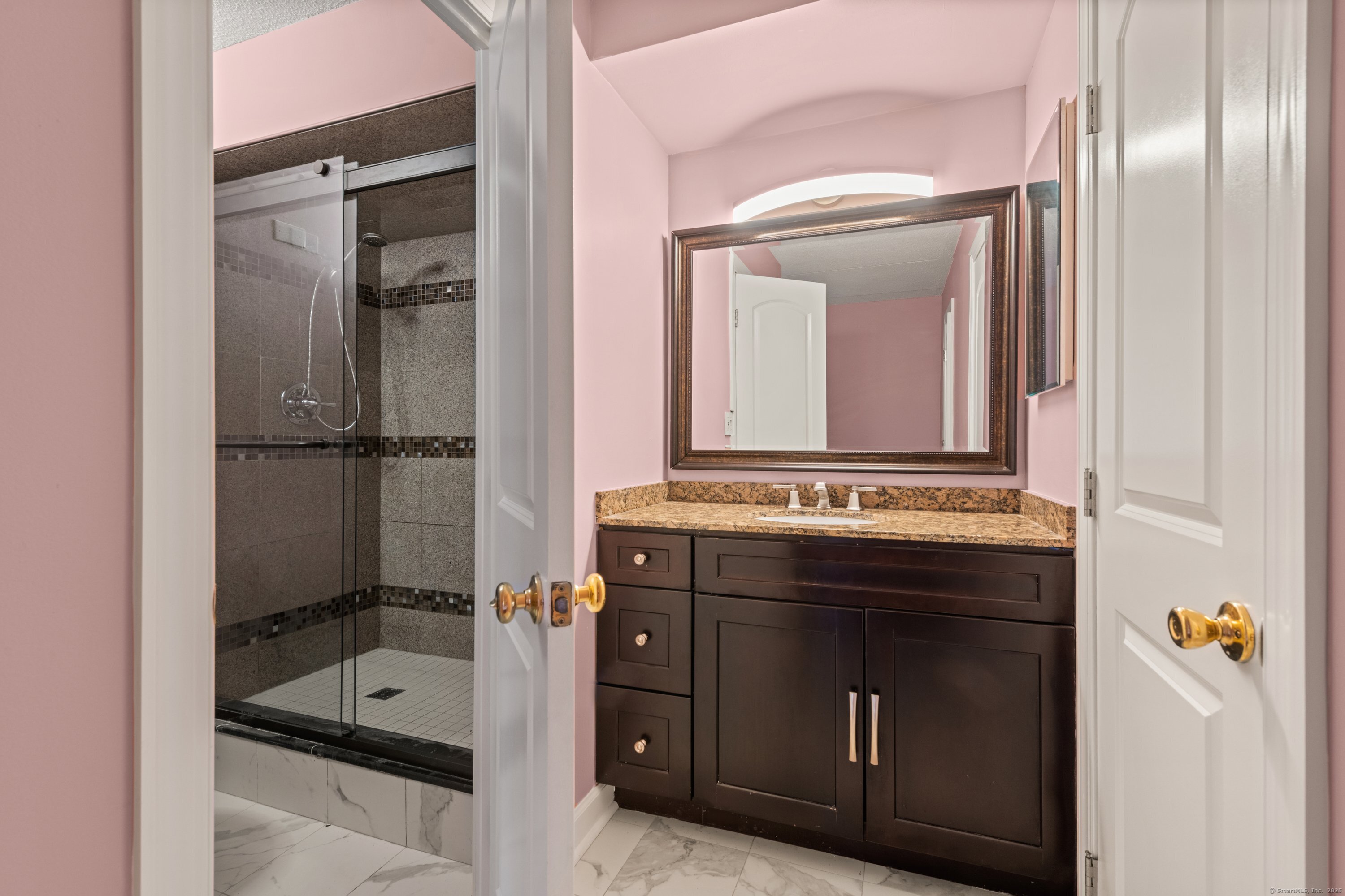 143 Hoyt Street, Unit 1A Stamford, CT 06905 - Photo 23 of 32 a bathroom with a tub a sink and mirror