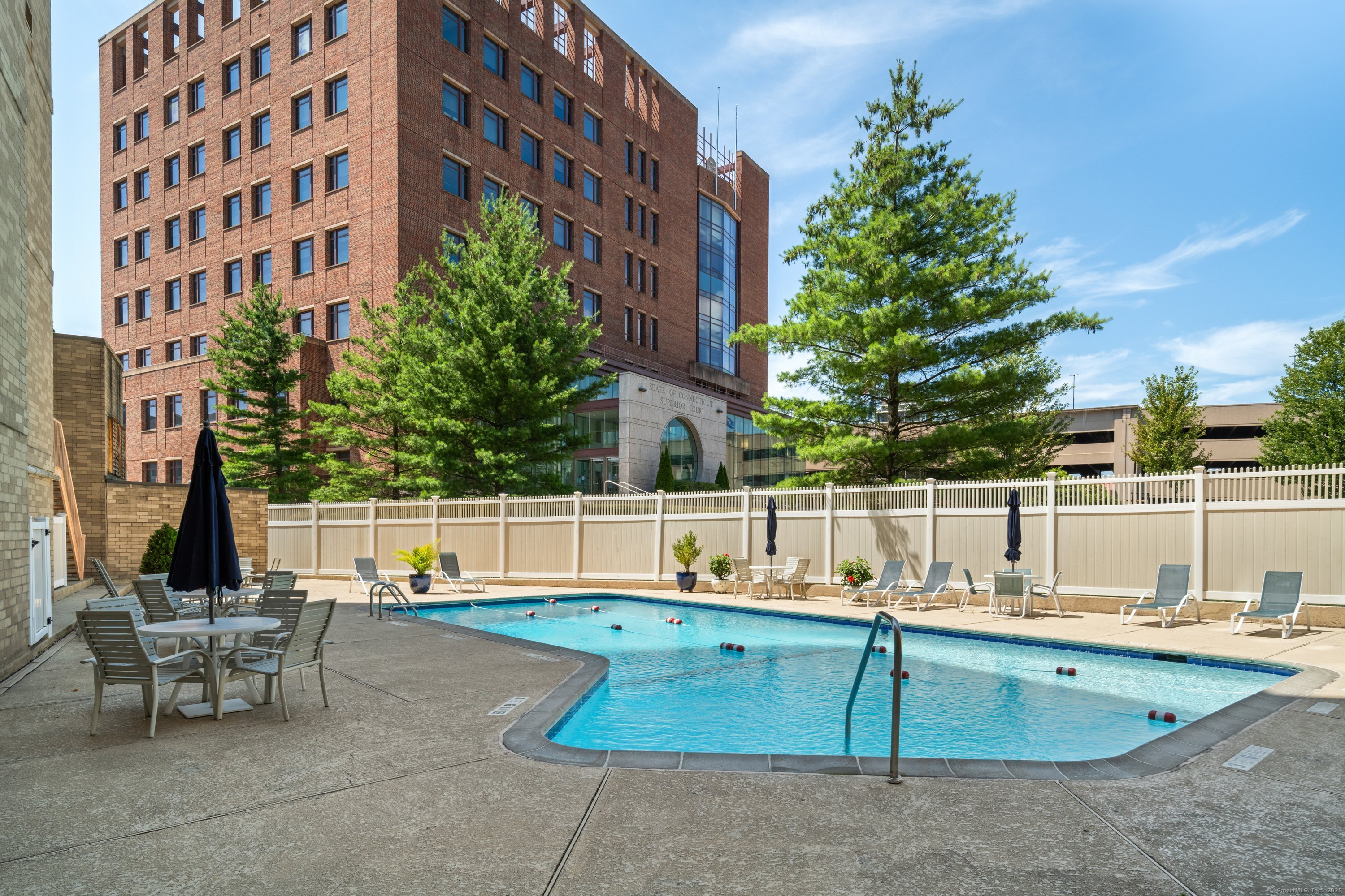 143 Hoyt Street, Unit 1A Stamford, CT 06905 - Photo 30 of 32 a view of a swimming pool with a lounge chairs