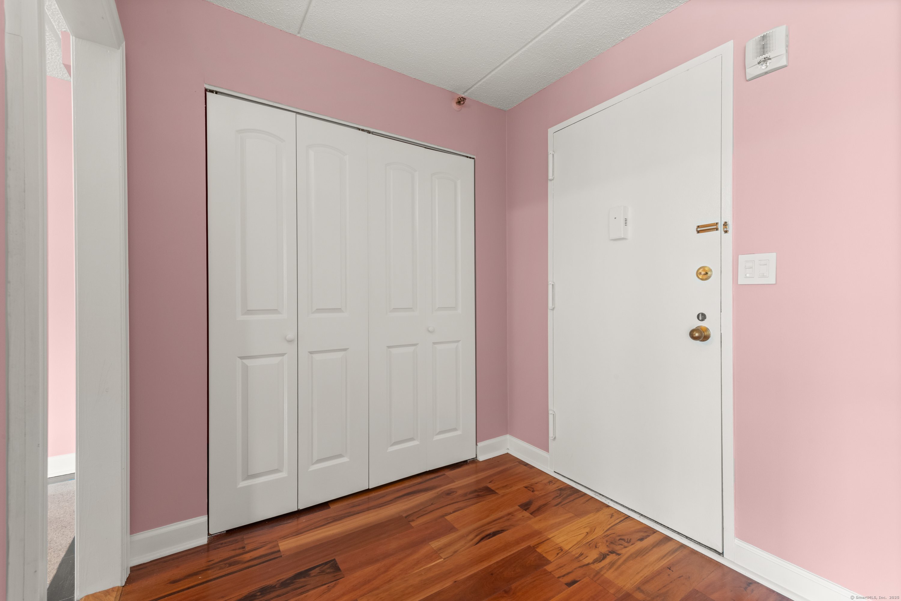 143 Hoyt Street, Unit 1A Stamford, CT 06905 - Photo 4 of 32 a view of an empty room with wooden floor