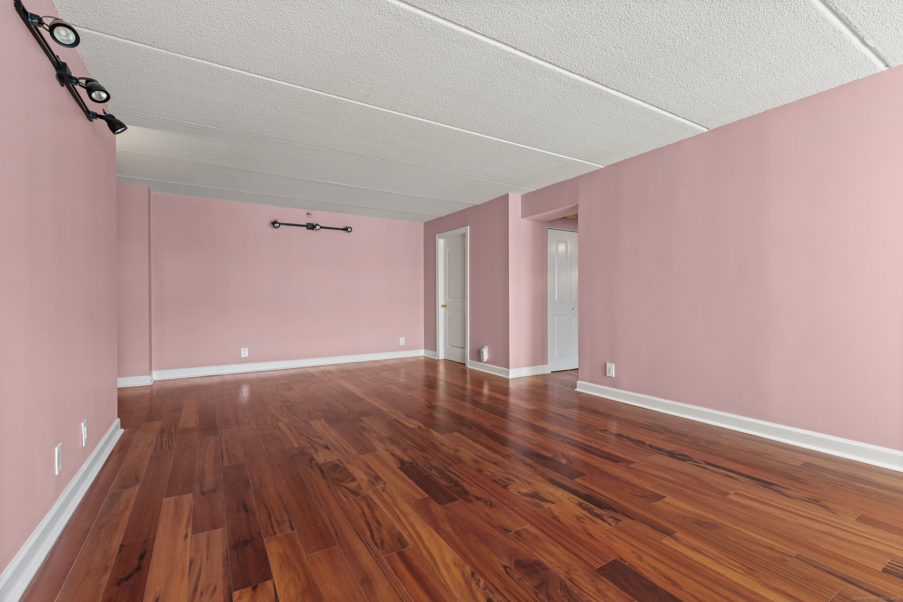 143 Hoyt Street, Unit 1A Stamford, CT 06905 - Photo 8 of 32 a view of an empty room with wooden floor