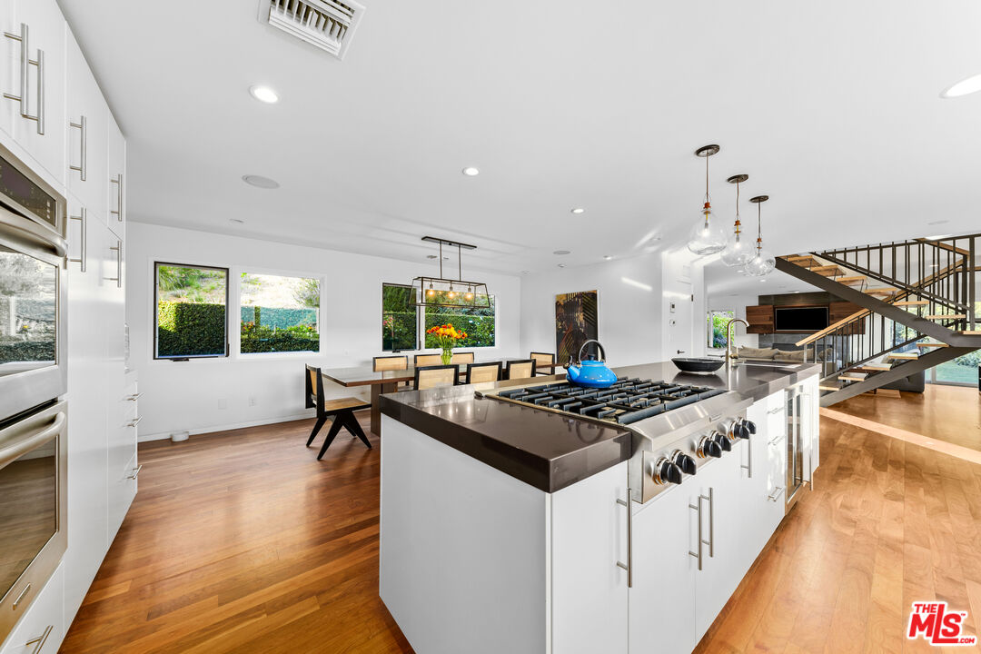 13501 Bayliss Road Los Angeles, CA 90049 - Photo 12 of 33 a kitchen that has a stove and a table