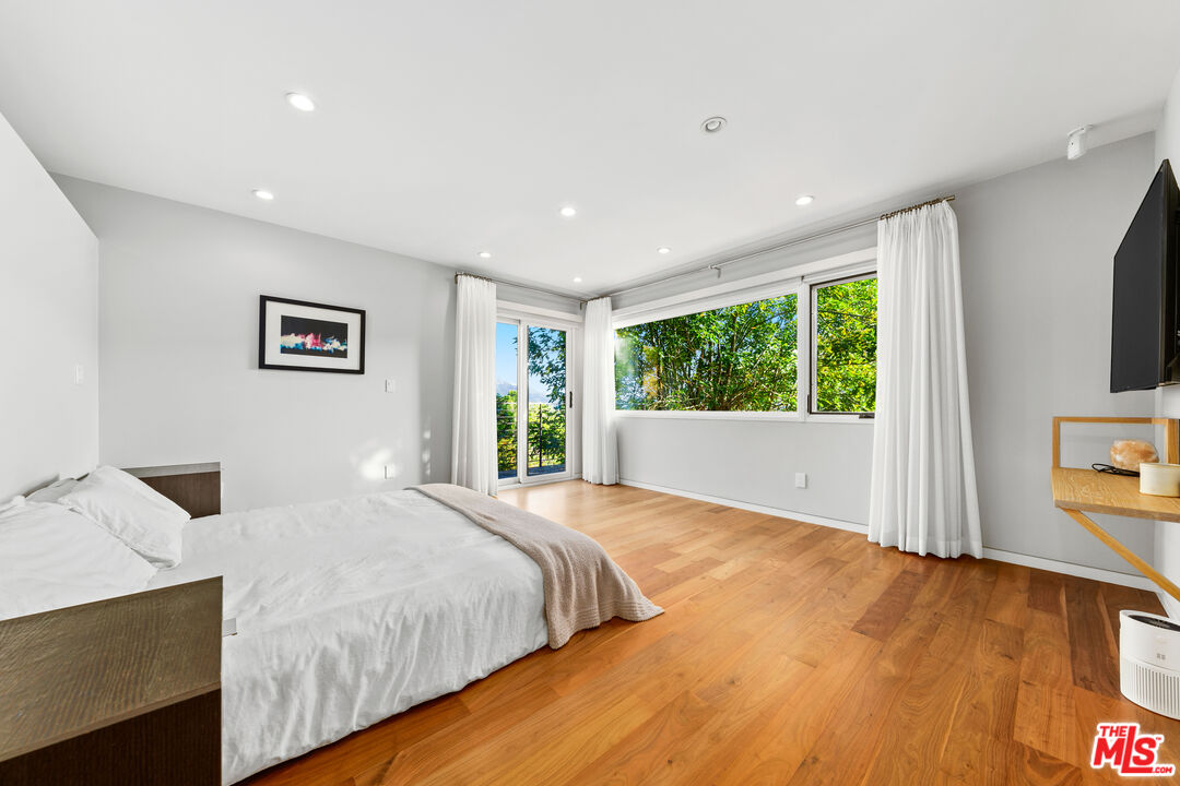 13501 Bayliss Road Los Angeles, CA 90049 - Photo 13 of 33 a bedroom with a bed and a window