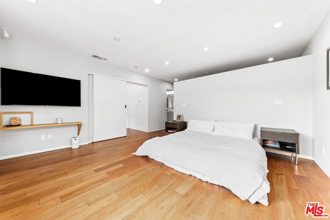 13501 Bayliss Road Los Angeles, CA 90049 - Photo 15 of 33 a bedroom with a bed and a flat screen tv