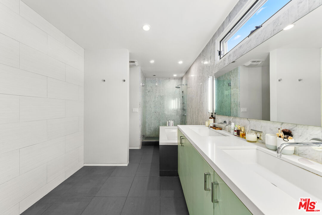 13501 Bayliss Road Los Angeles, CA 90049 - Photo 17 of 33 a bathroom with a sink double vanity granite tub and shower