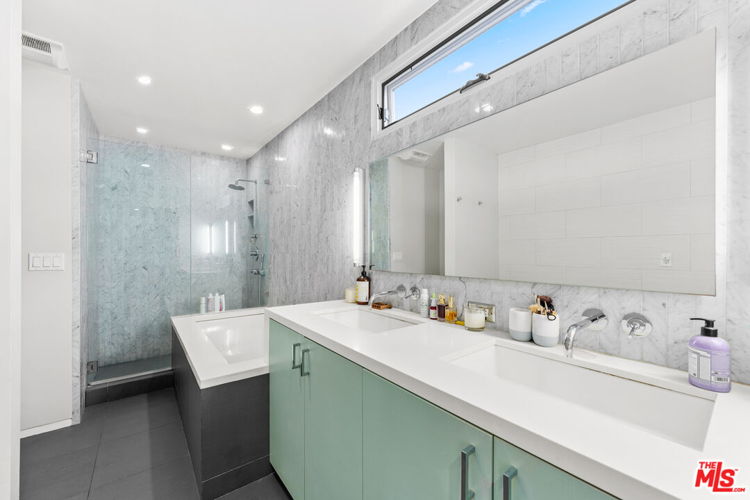 13501 Bayliss Road Los Angeles, CA 90049 - Photo 18 of 33 a bathroom with a sink mirror and vanity