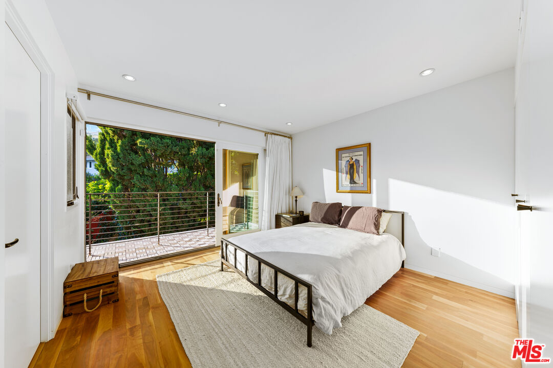 13501 Bayliss Road Los Angeles, CA 90049 - Photo 19 of 33 a bedroom with a bed and a large window