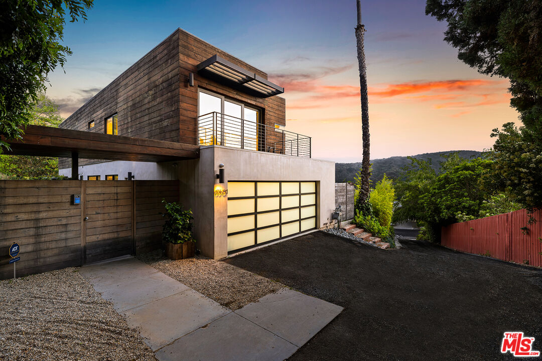 13501 Bayliss Road Los Angeles, CA 90049 - Photo 2 of 33 a front view of a house with a garage