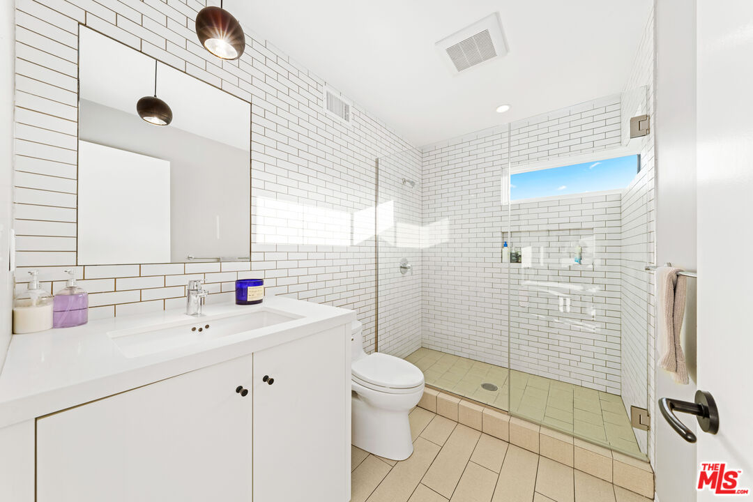 13501 Bayliss Road Los Angeles, CA 90049 - Photo 21 of 33 a bathroom with a sink a toilet and shower