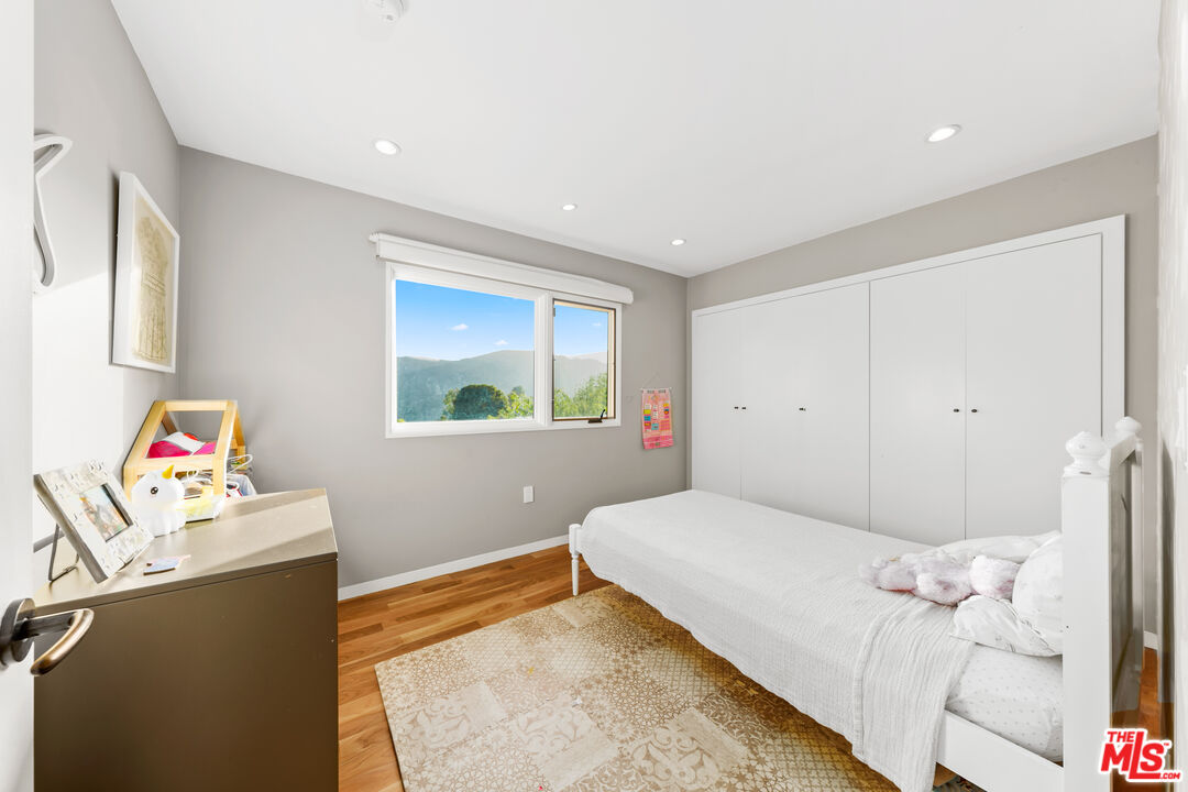 13501 Bayliss Road Los Angeles, CA 90049 - Photo 22 of 33 a bedroom with a bed and a window