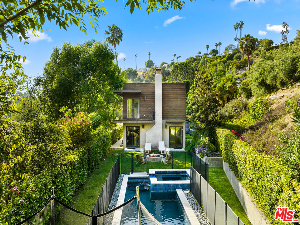 13501 Bayliss Road Los Angeles, CA 90049 - Photo 25 of 33 a front view of a house with a yard