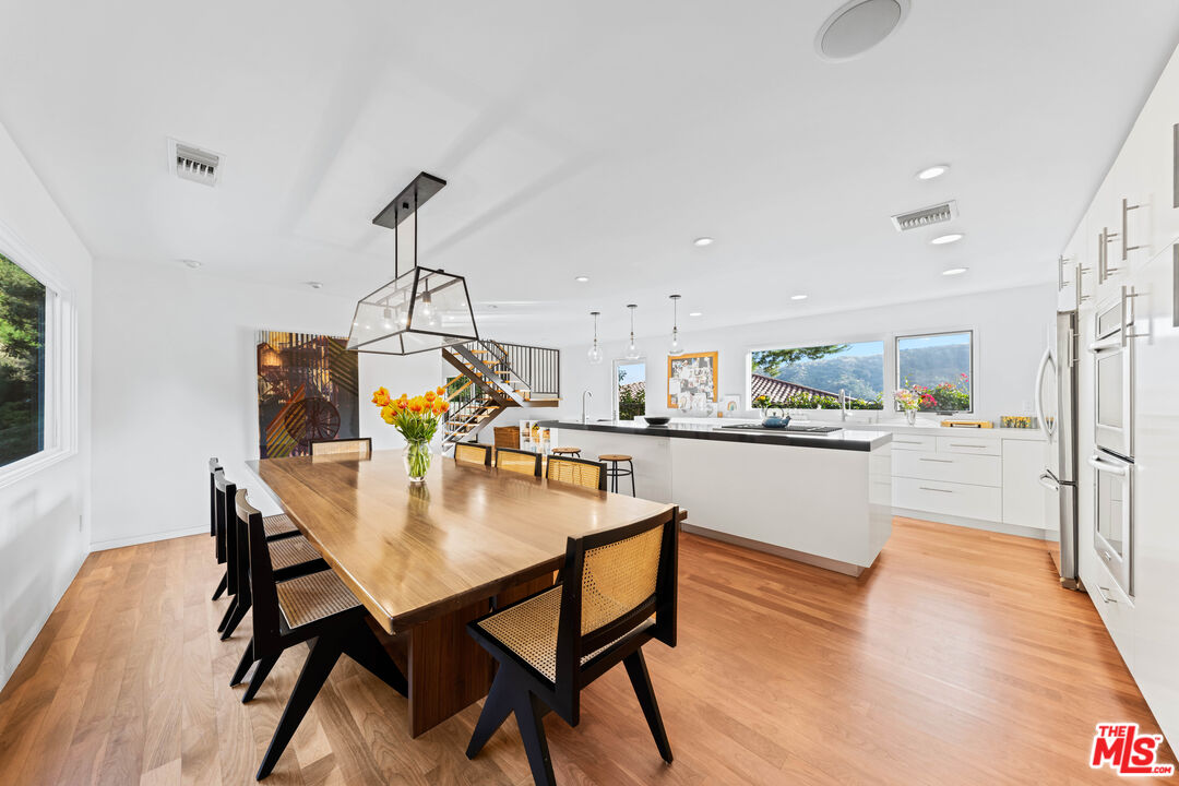 13501 Bayliss Road Los Angeles, CA 90049 - Photo 8 of 33 a dining room with furniture and wooden floor