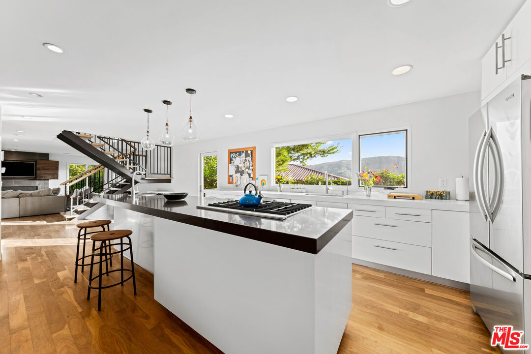 13501 Bayliss Road Los Angeles, CA 90049 - Photo 9 of 33 a kitchen with appliances cabinets and a table
