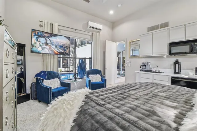 a bedroom with furniture and a flat screen tv