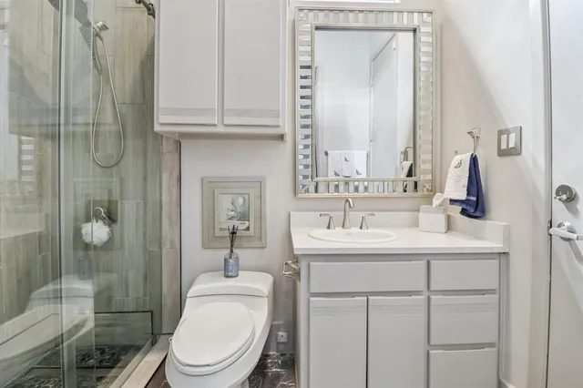 a bathroom with a toilet a sink and shower