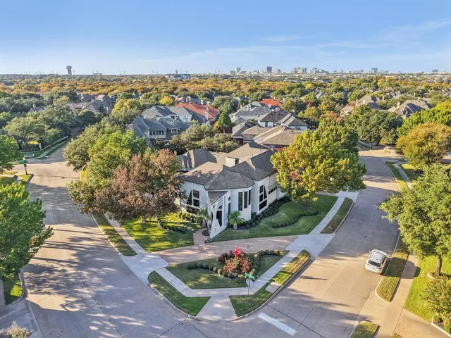 an aerial view of residential houses with outdoor space