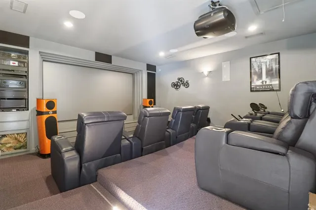 a living room with furniture a flat screen tv and gym equipment