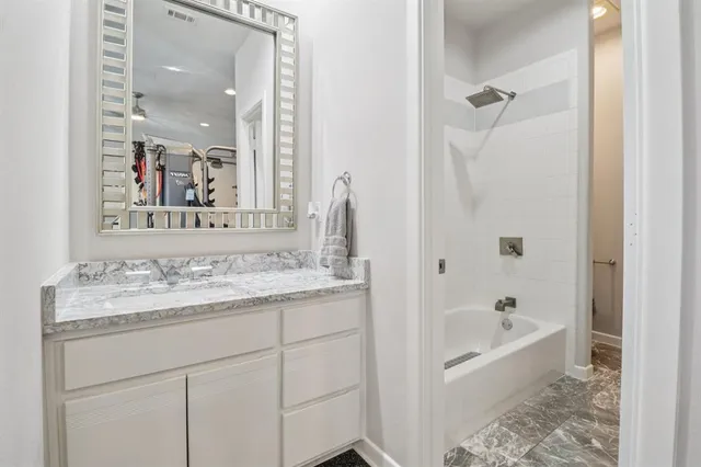 a bathroom with a bathtub and a sink