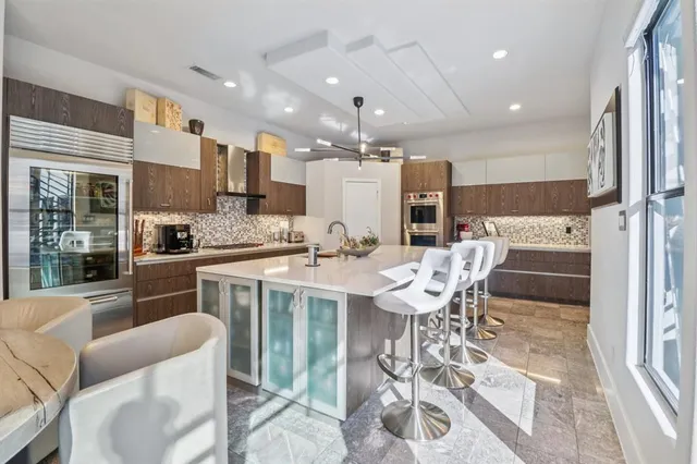 a large kitchen with a table and chairs
