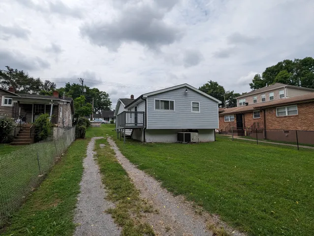 a aerial view of a house next to a big yard and large trees