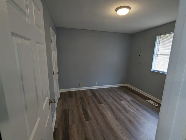 a view of an empty room and wooden floor