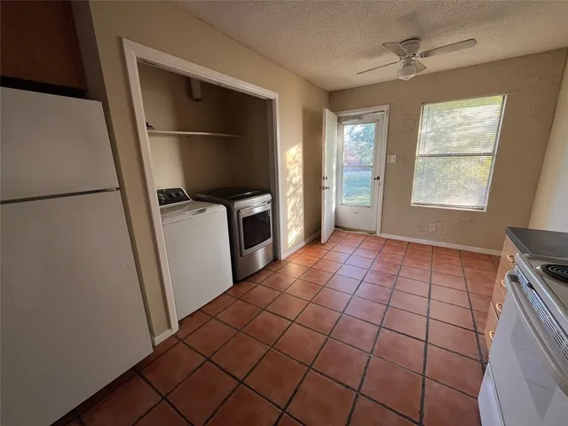 a view of a kitchen with a sink and a refrigerator